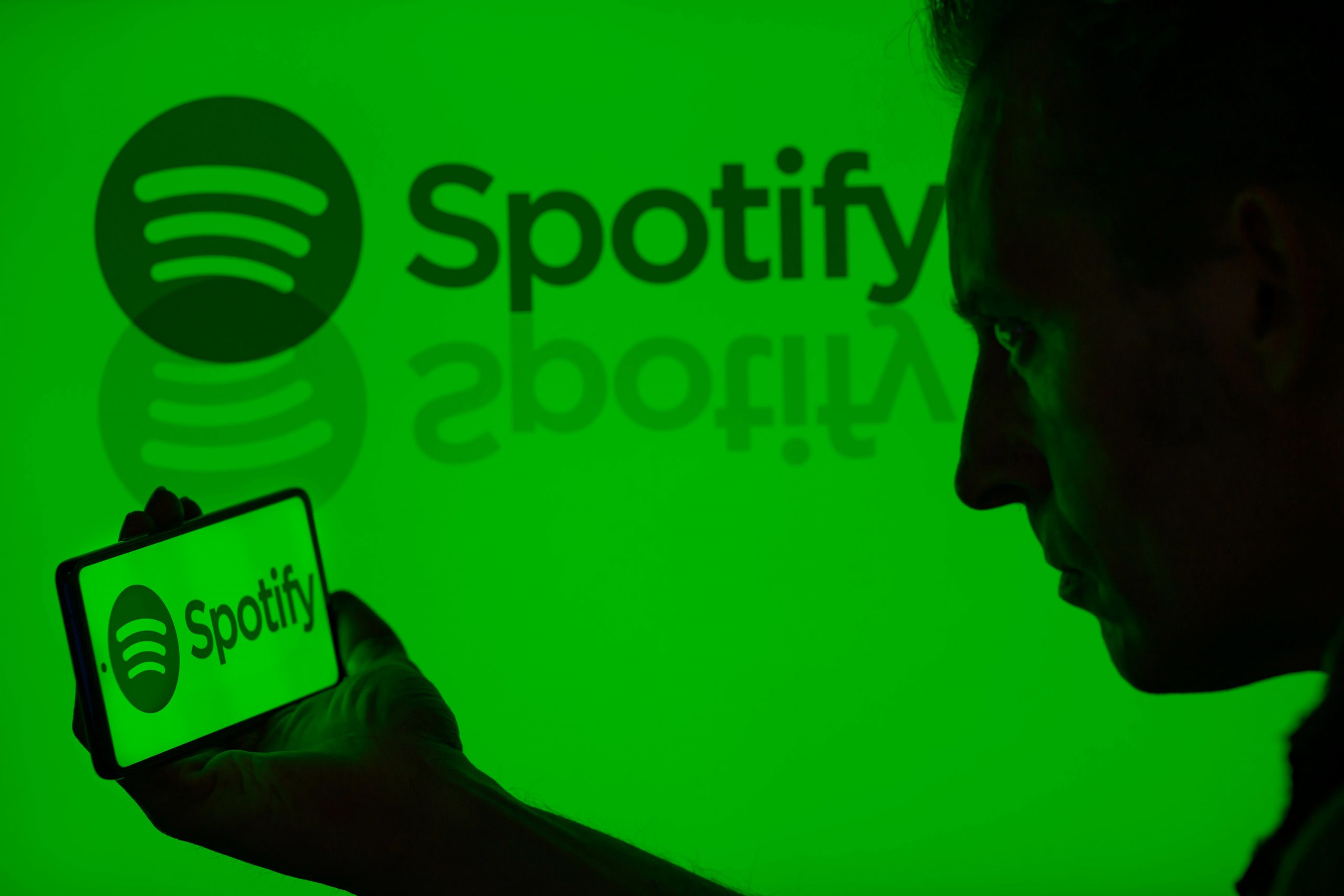 The Spotify logo is being displayed on a smartphone with Spotify visible in the background in this photo illustration in Brussels, Belgium, on May 11, 2024.