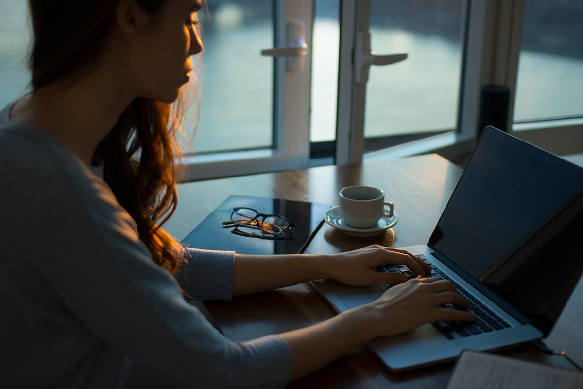 Woman working on laptop.