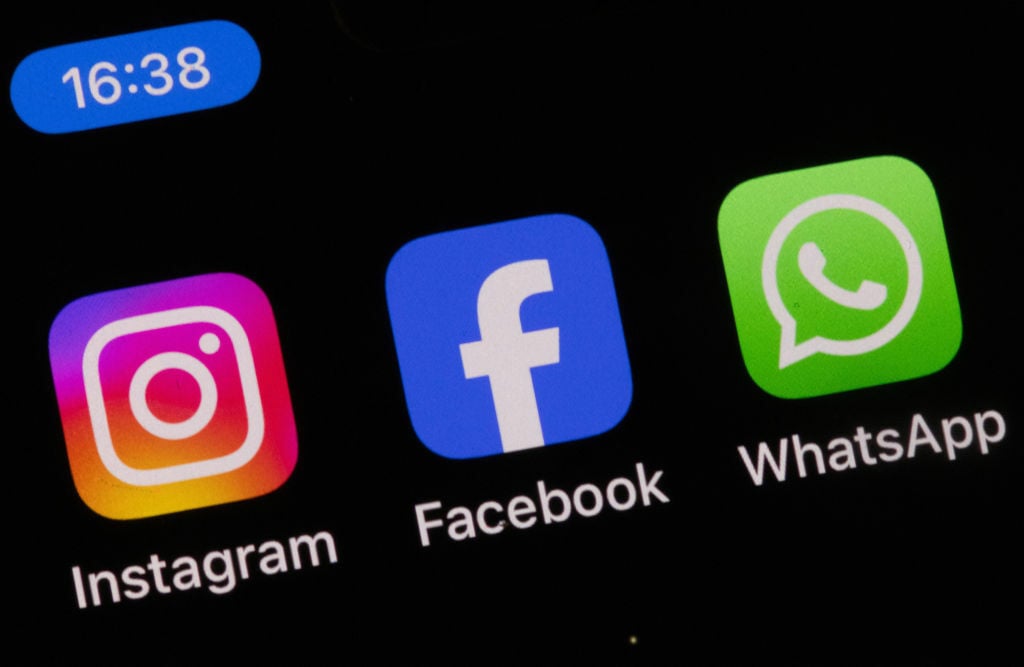 Instagram, Facebook, and WhatsApp icons on a smartphone screen