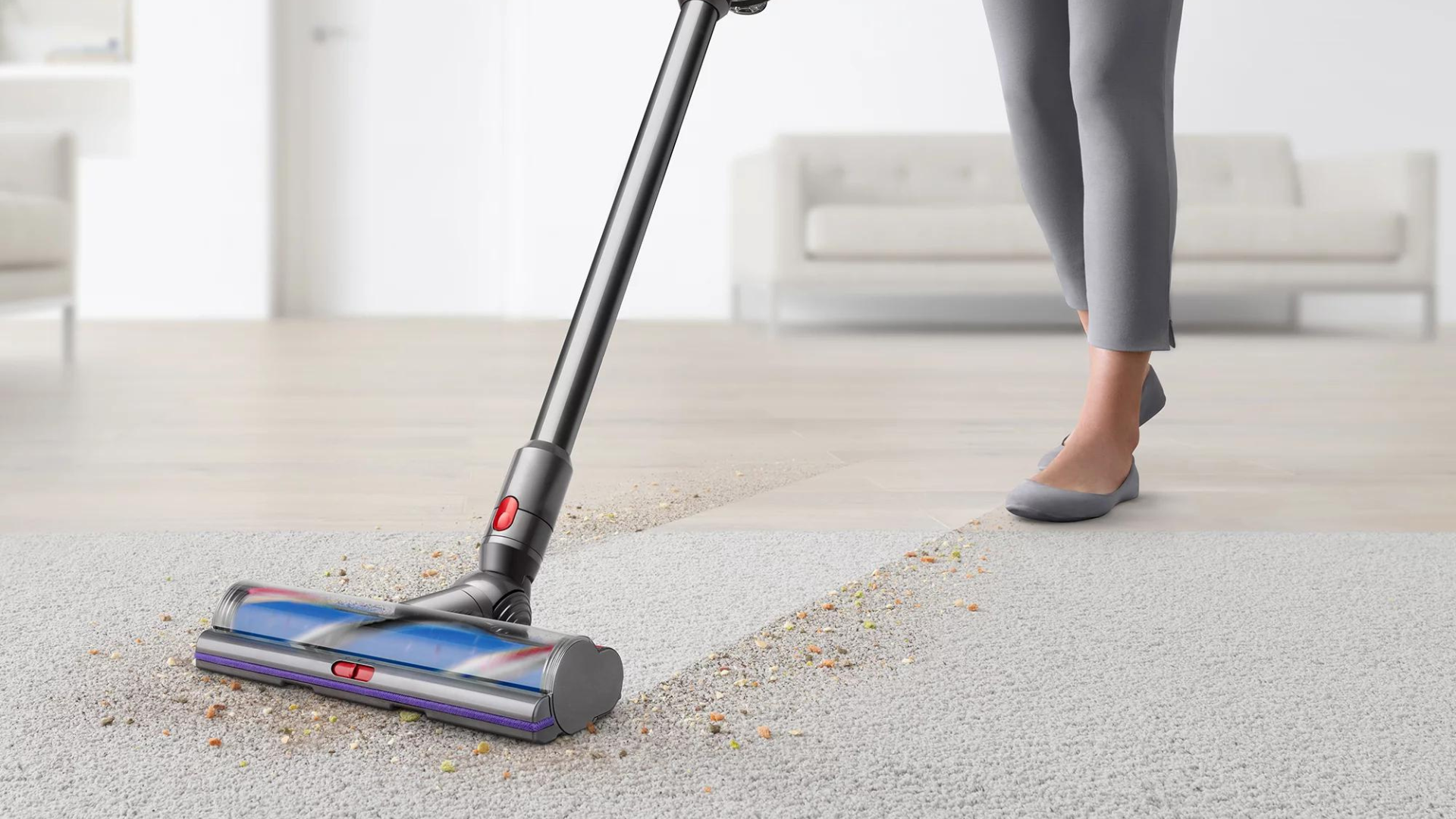 A person using the Dyson V11 on carpet