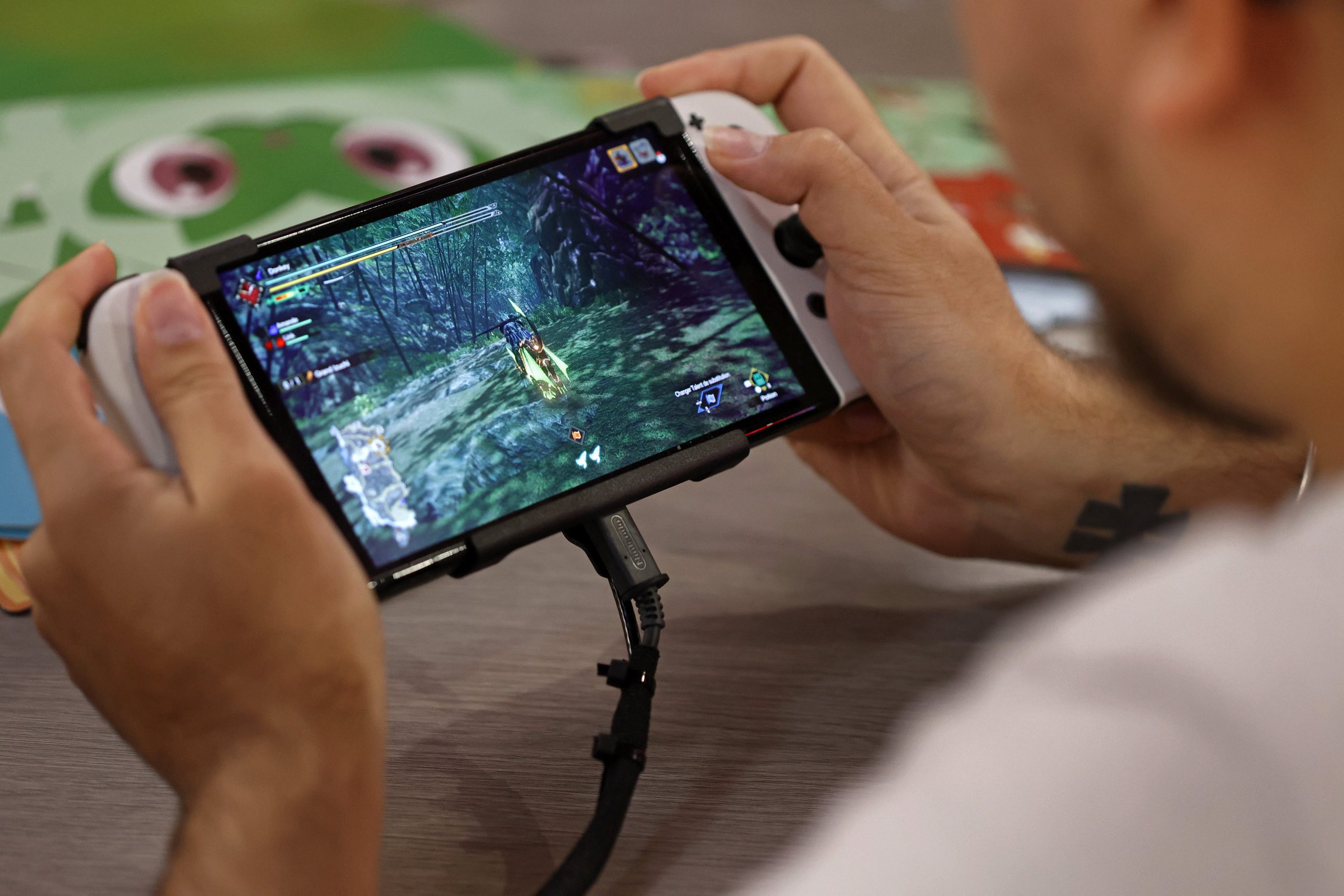 A gamer plays a video game on a Nintendo Switch console, OLED model during Paris Games Week 2022 at Parc des Expositions Porte de Versailles on November 03, 2022 in Paris, France. 