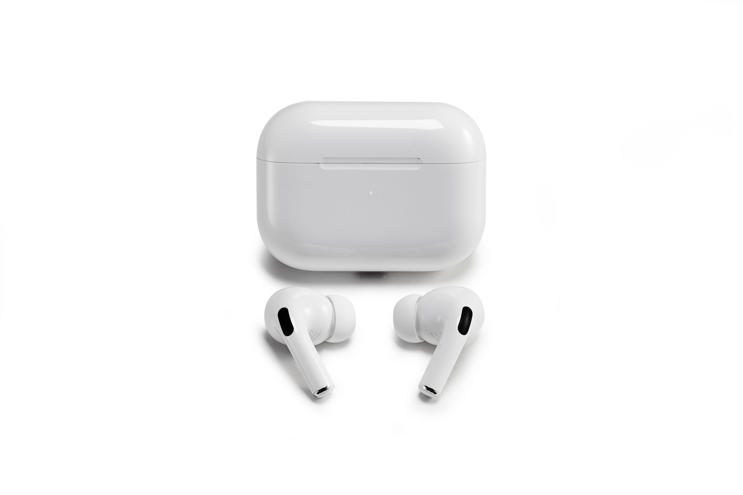 A pair of Apple Airpods Pro, out of their Bluetooth charging case, reading to be connected with a Mac or PC