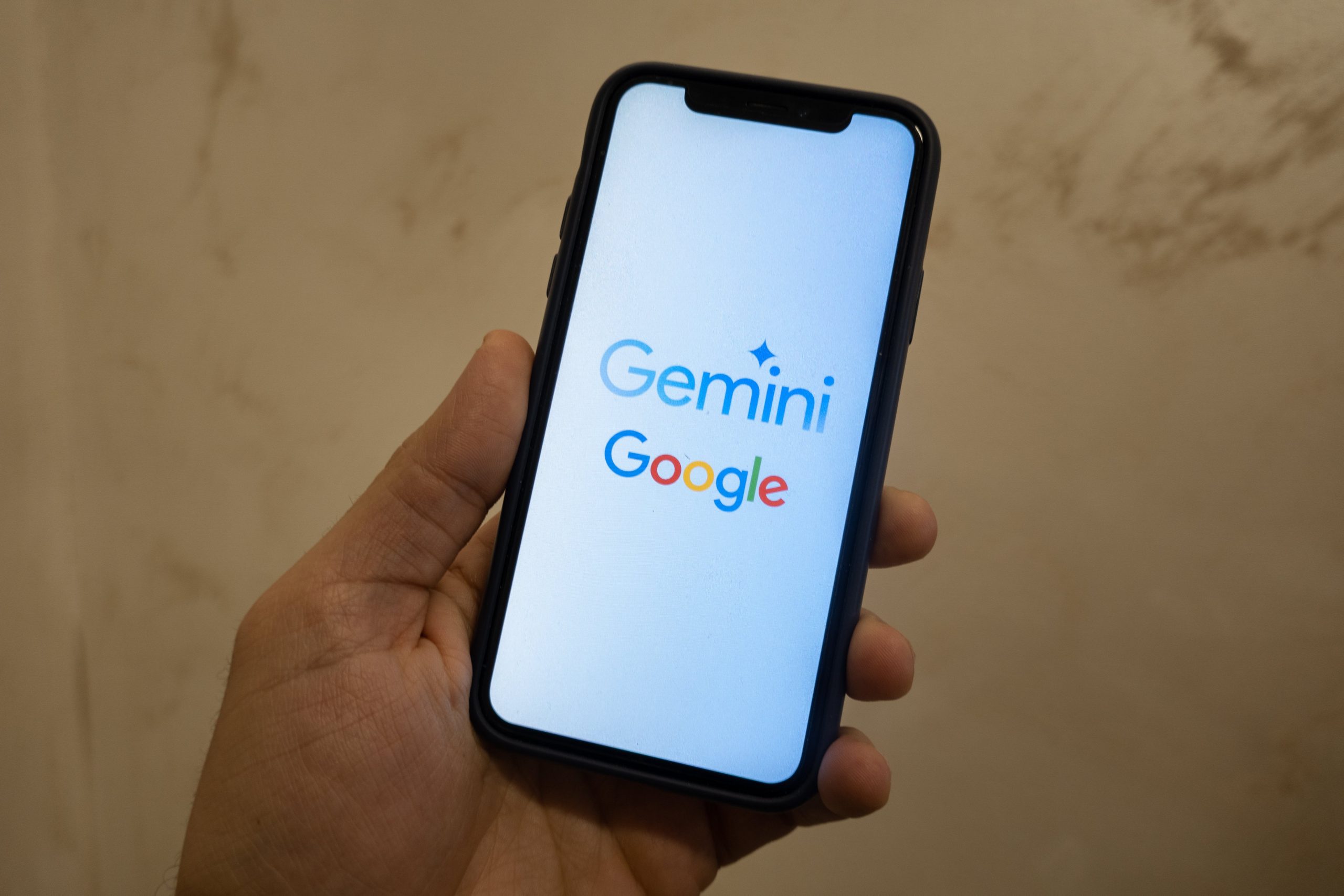 A smartphone showing the Goole and Gemini logos