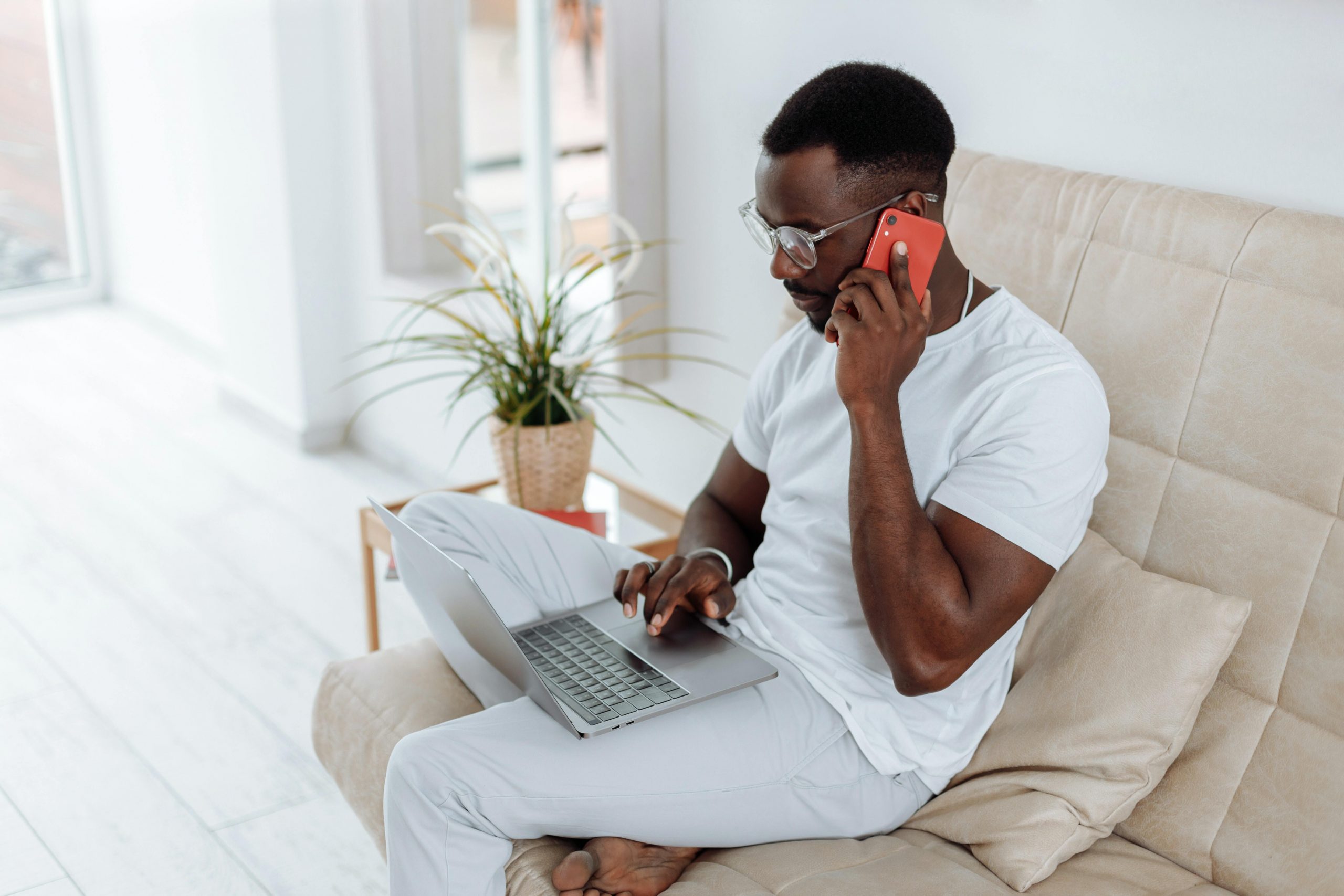 Black man on the phone using a laptop