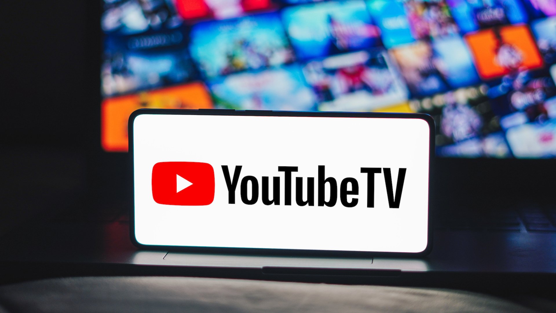 In this photo illustration, the YouTube TV logo is displayed on a smartphone screen.