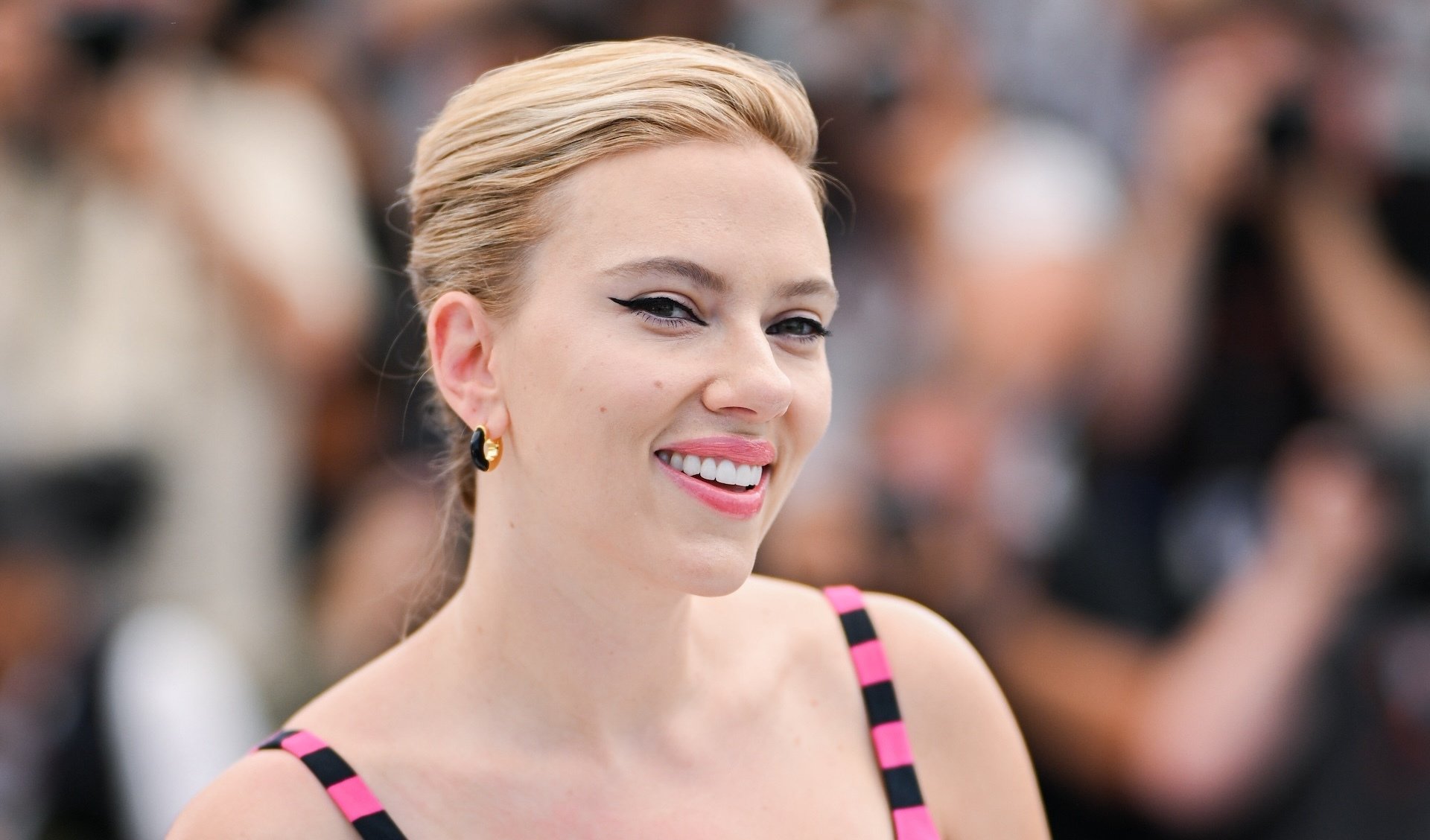 Scarlett Johansson smiles directly at the camera.