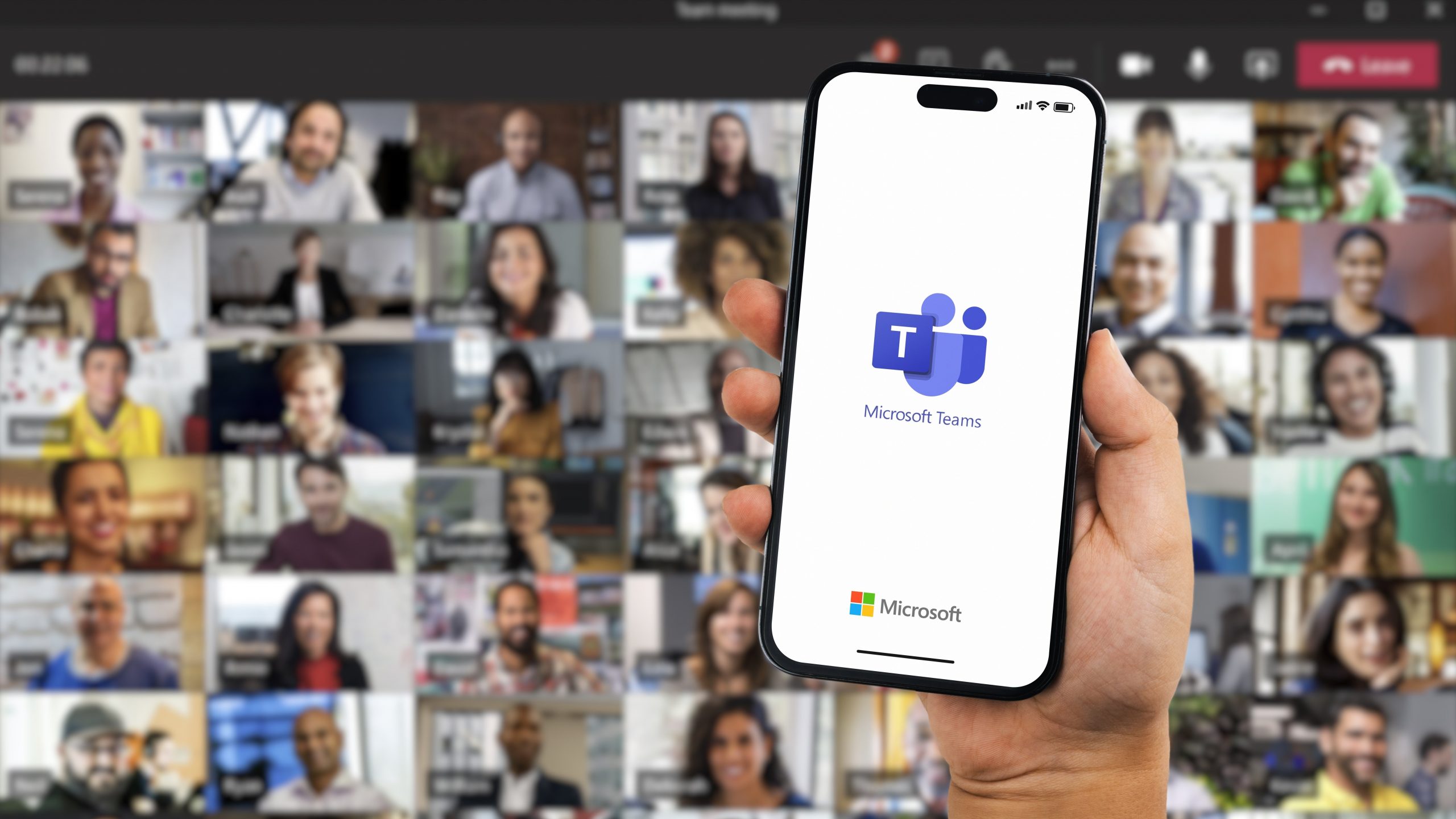 Microsoft Teams on mobile with a massive video call behind it