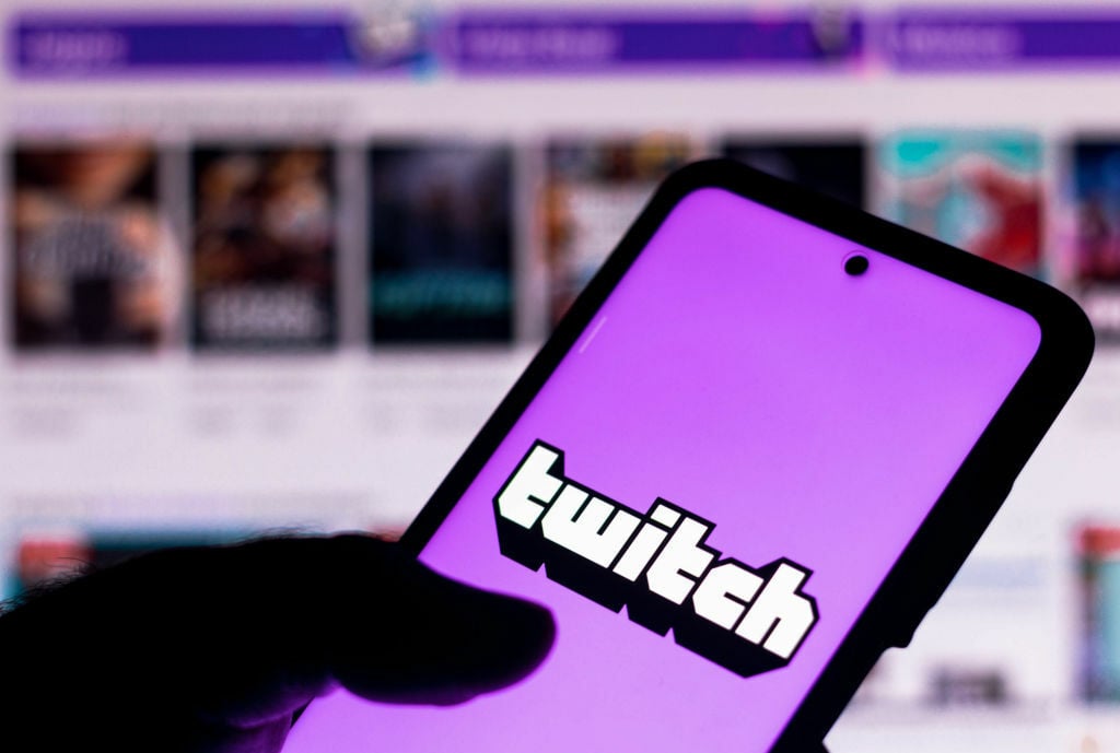 In this photo illustration the Twitch logo seen displayed on a smartphone.