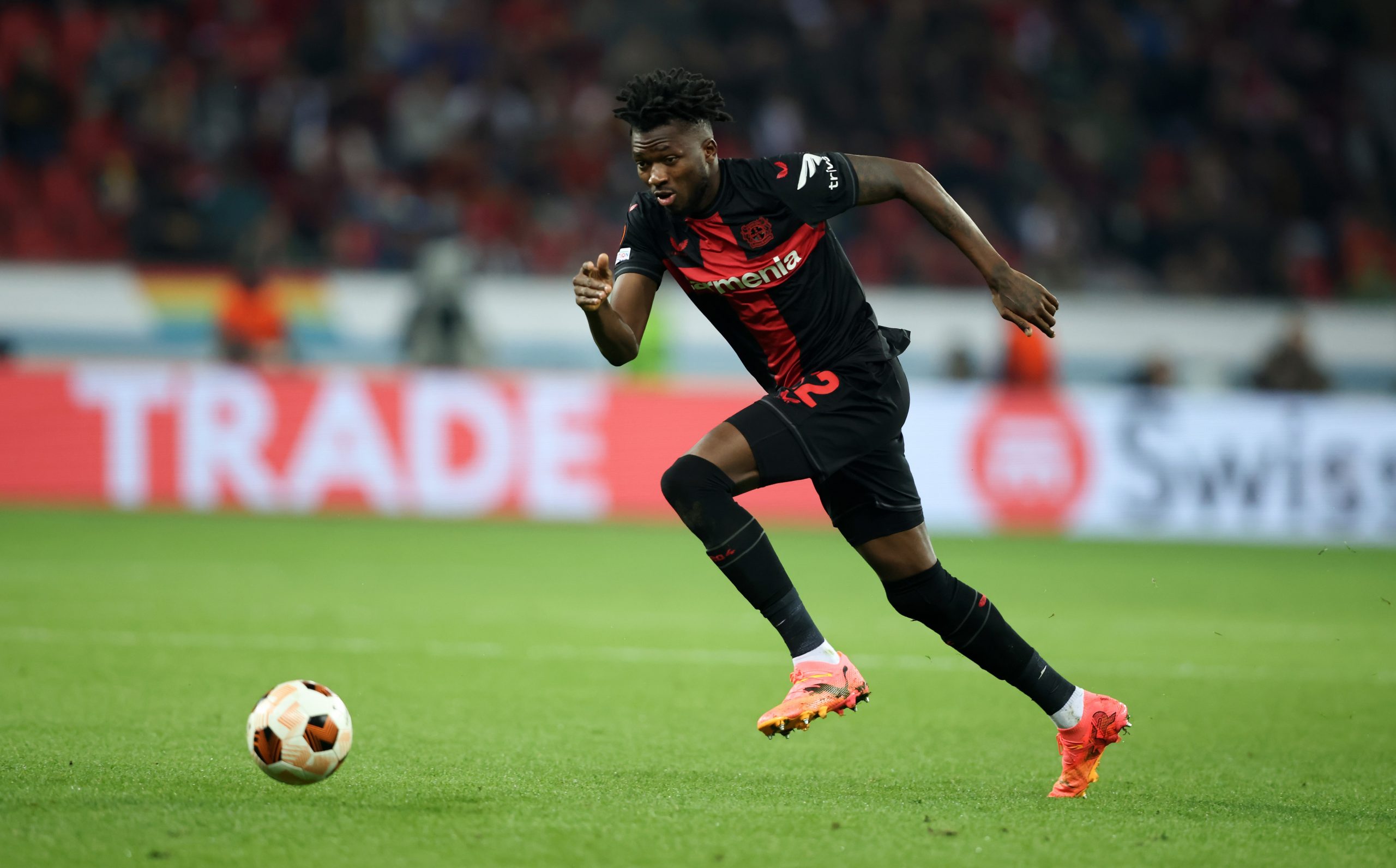 Edmond Tapsoba of Bayer Leverkusen runs with a ball