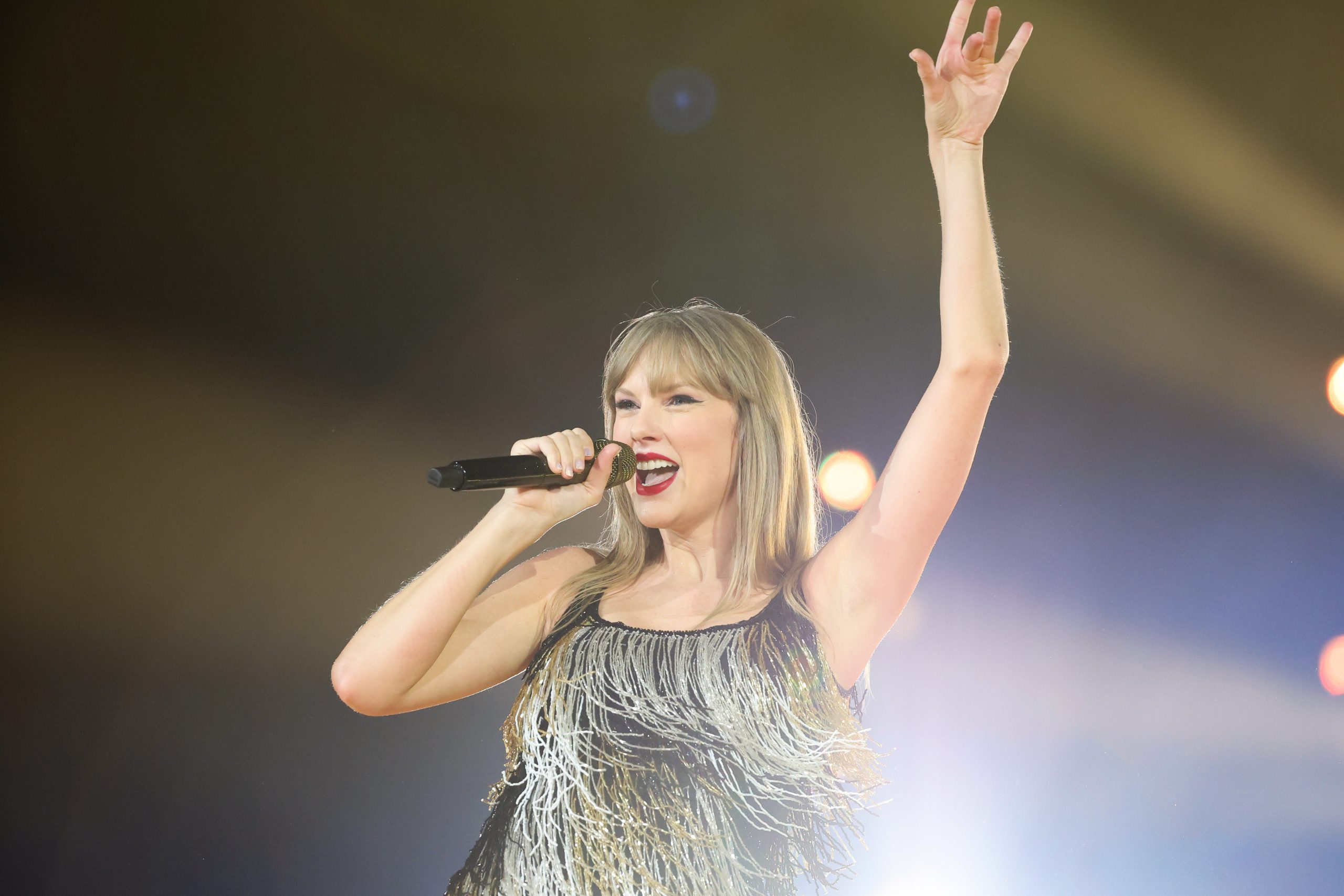 Taylor Swift performing in a sparkly dress.