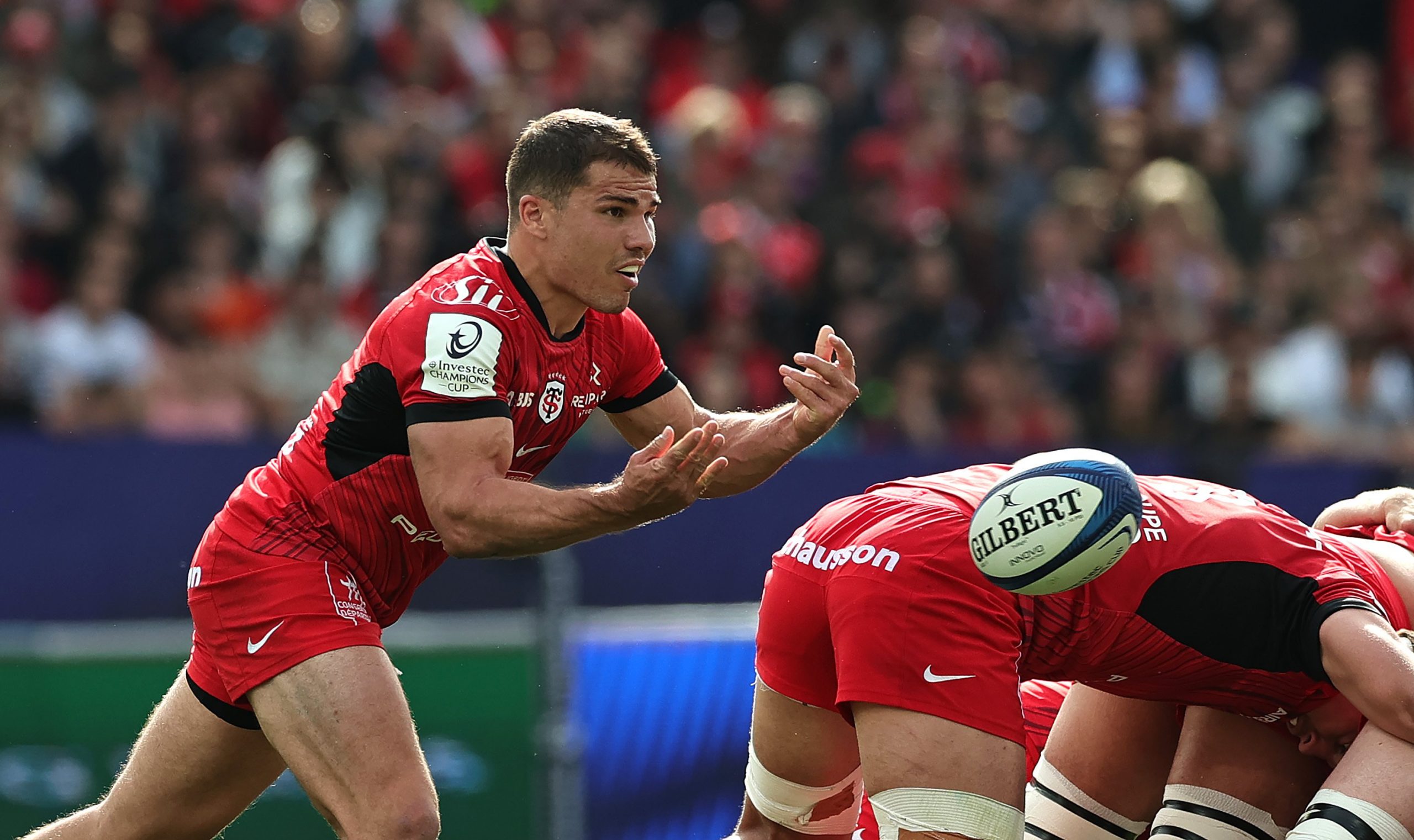 Antoine Dupont of Toulouse passes the ball