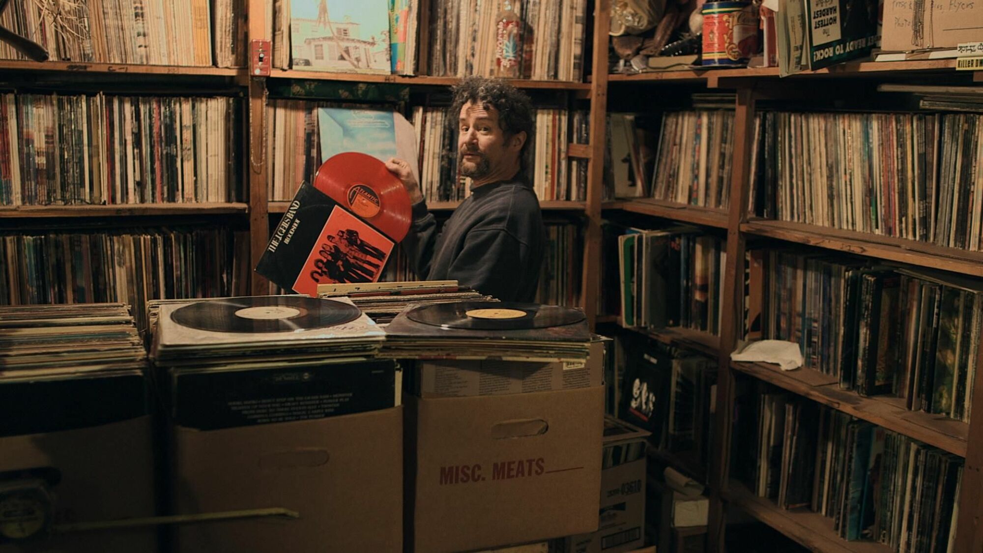 A record store owner looks over his stock. 