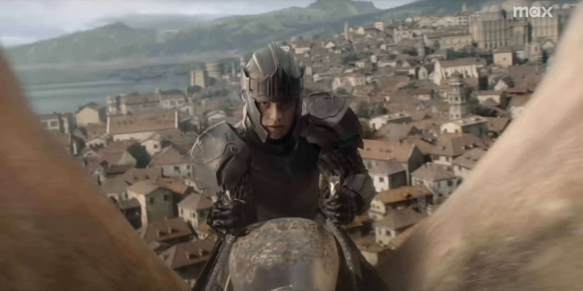 Tom Glynn-Carney as Aegon Targaryen, riding a gold dragon over King's Landing.