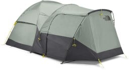 a green north face tent on a white background