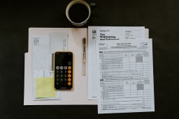 Taxes and calculator on table.
