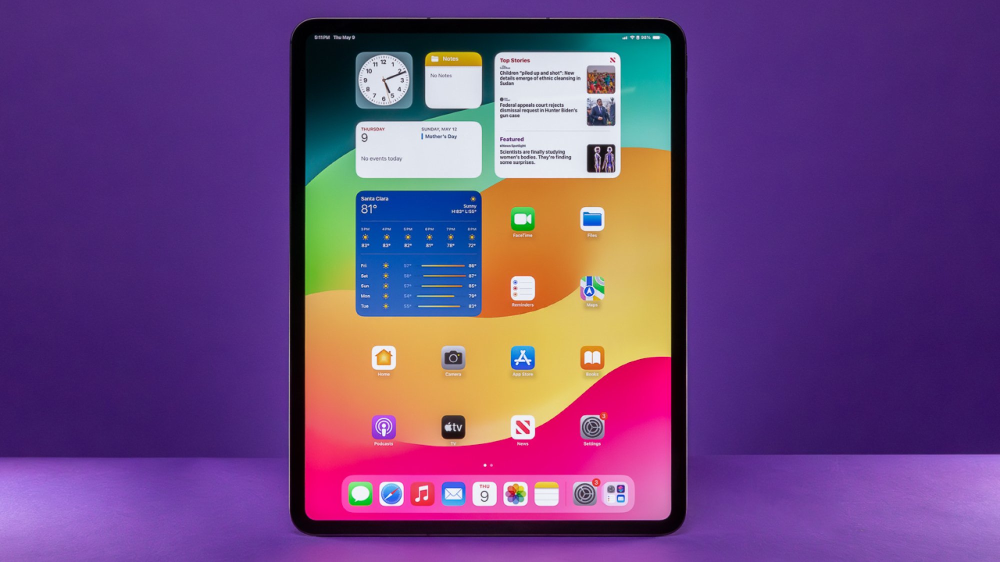 iPad Pro 2024 in portrait mode against a purple background