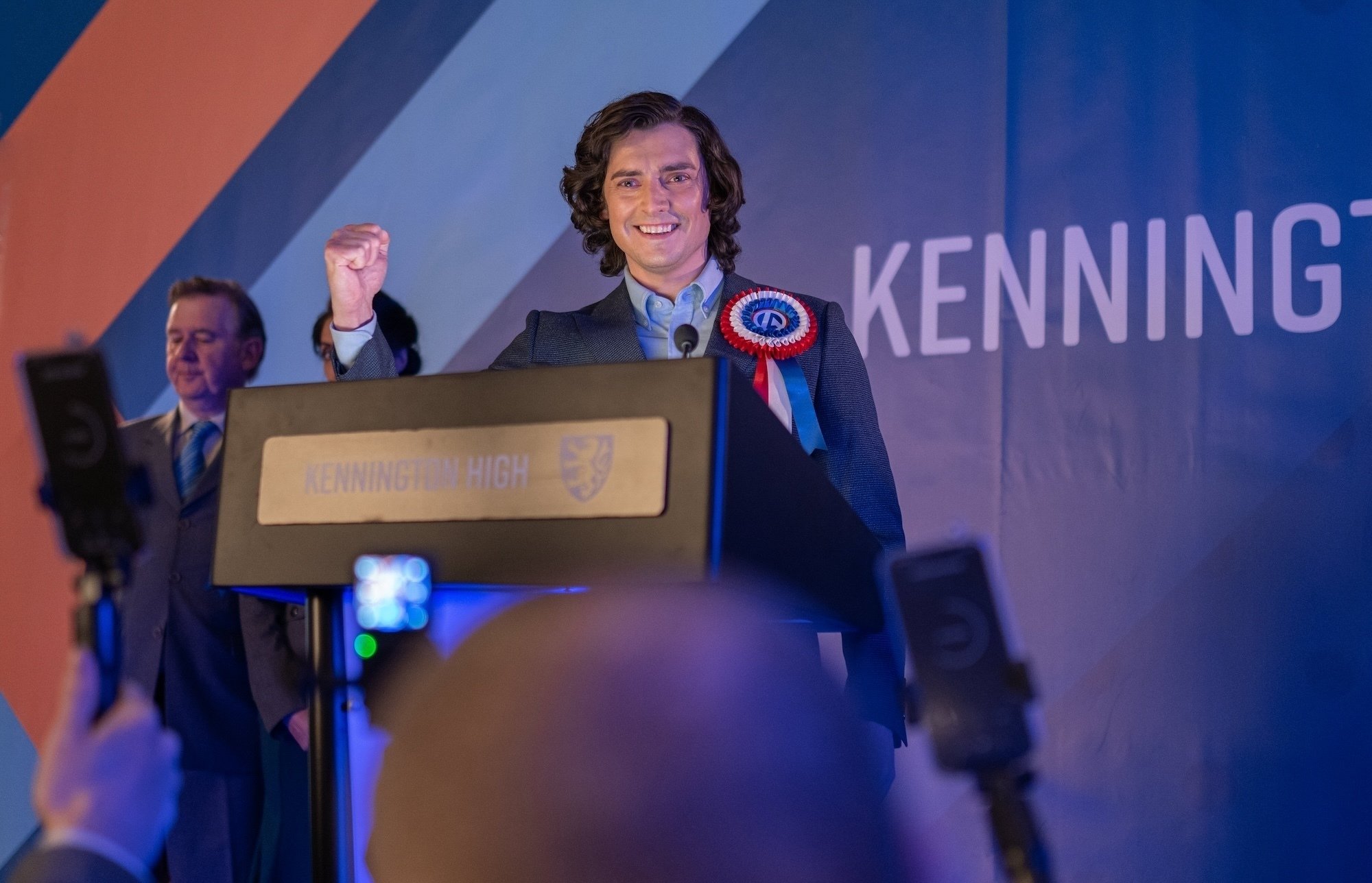 Politician Roger ap Gwilliam giving a speech with a rosette on.