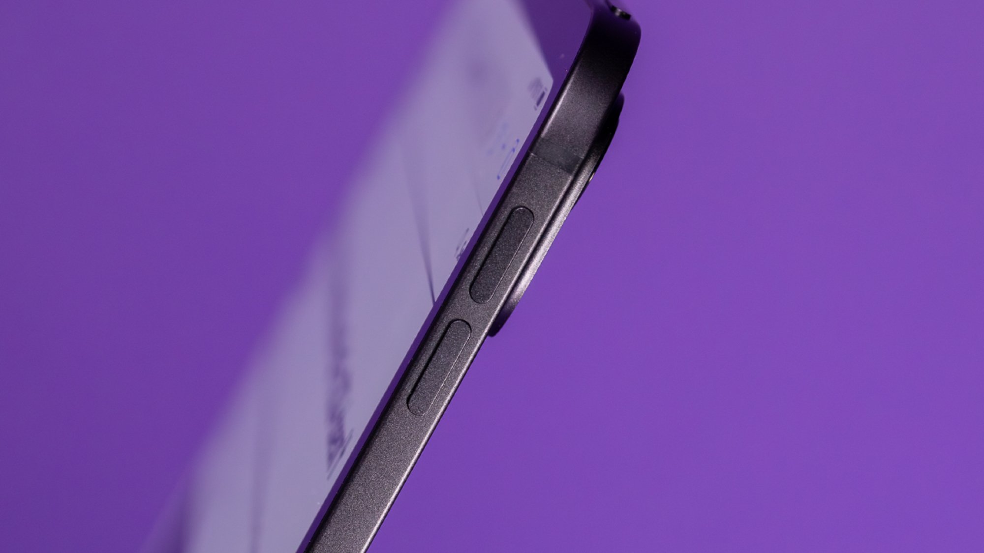 Side of the 13-inch Space Black iPad Pro against purple background