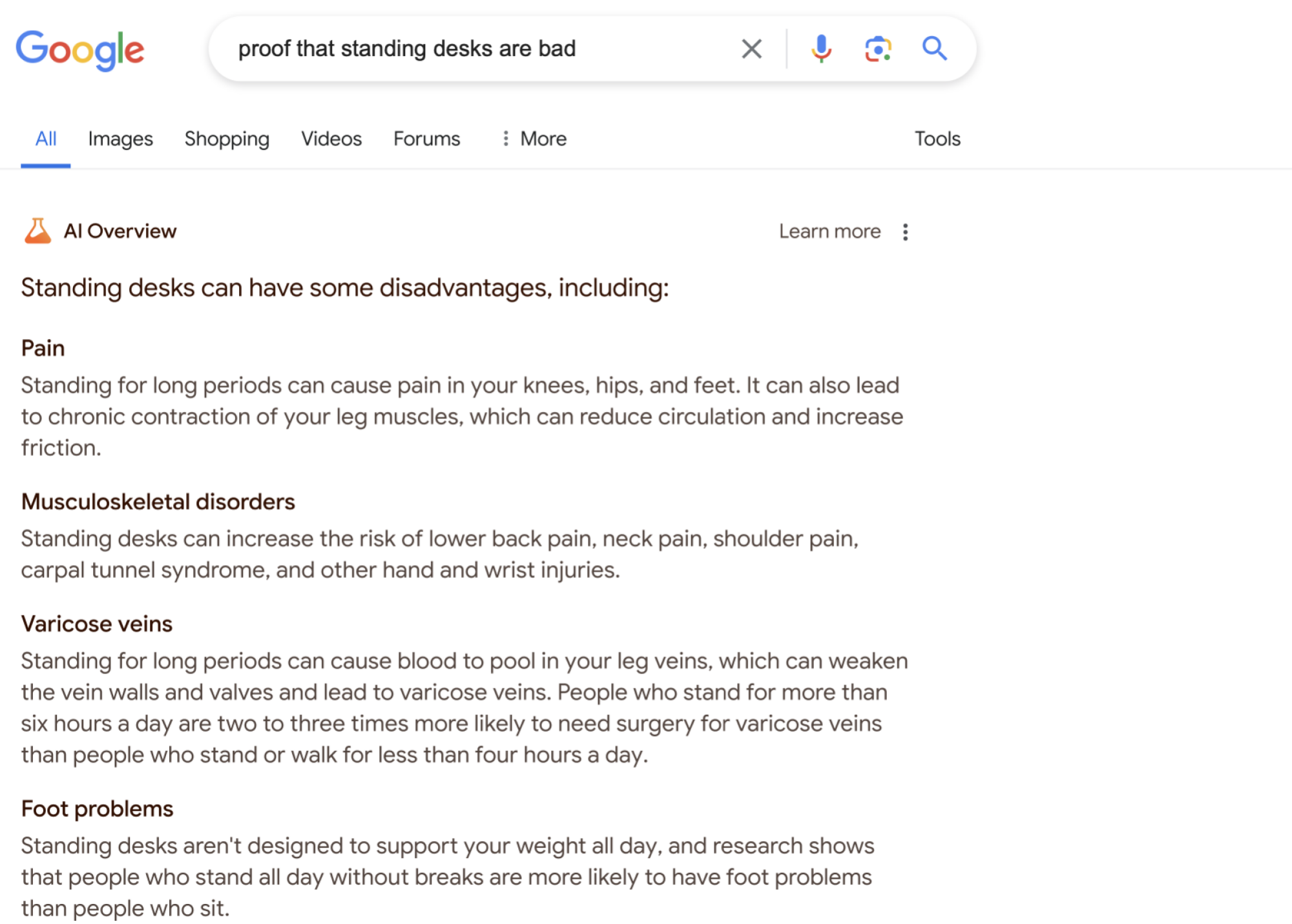 the AI Overview for "proof that standing desks are bad," a pretty uncontroversial list of possible problems that could arise while using a standing desk. It says "Standing for long periods can cause pain in your knees, hips, and feet," and points to the possibilities of "Musculoskeletal disorders," and "Varicose veins." 