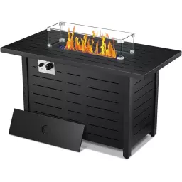 Black fire pit with flames in glass casing and cover leaning against side