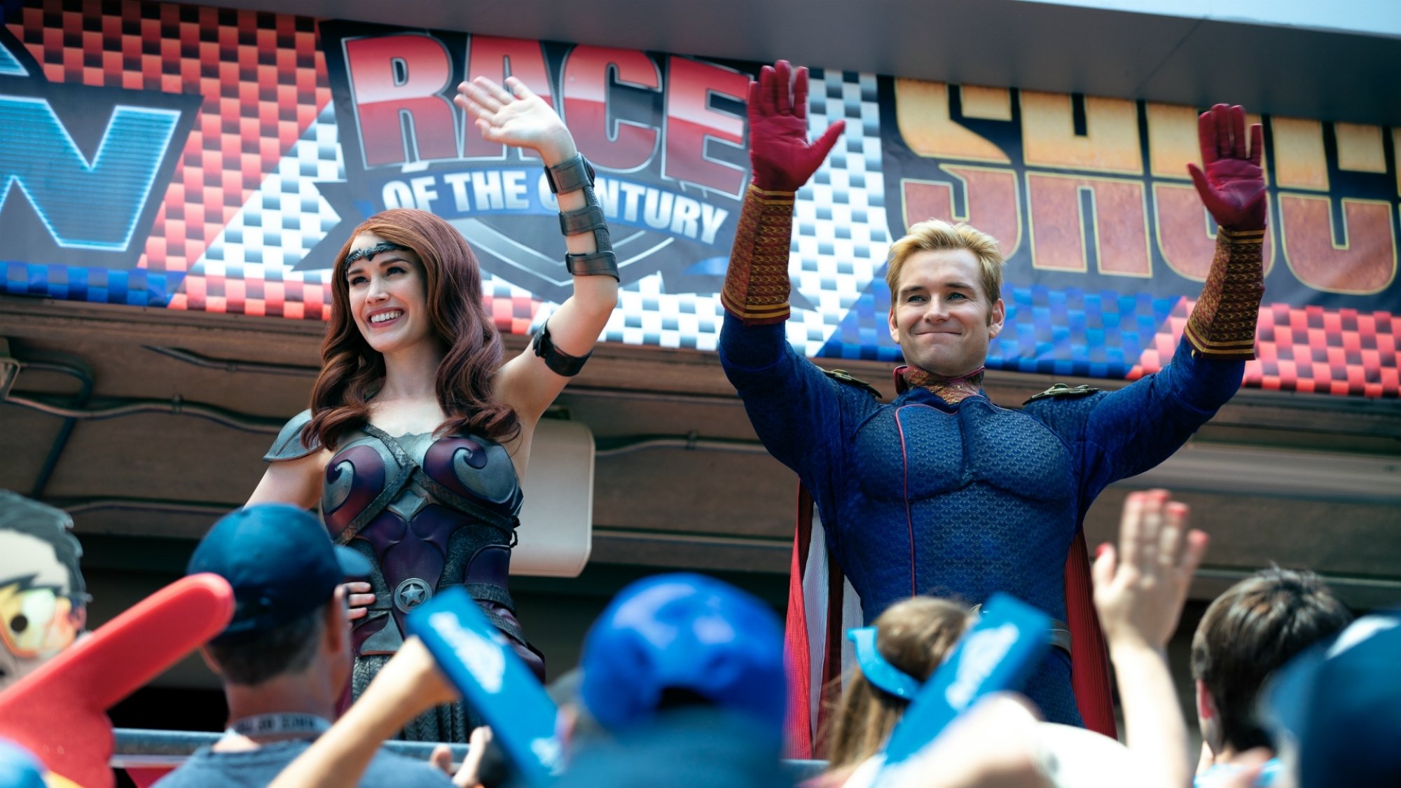 Superheroes wave at fans. 