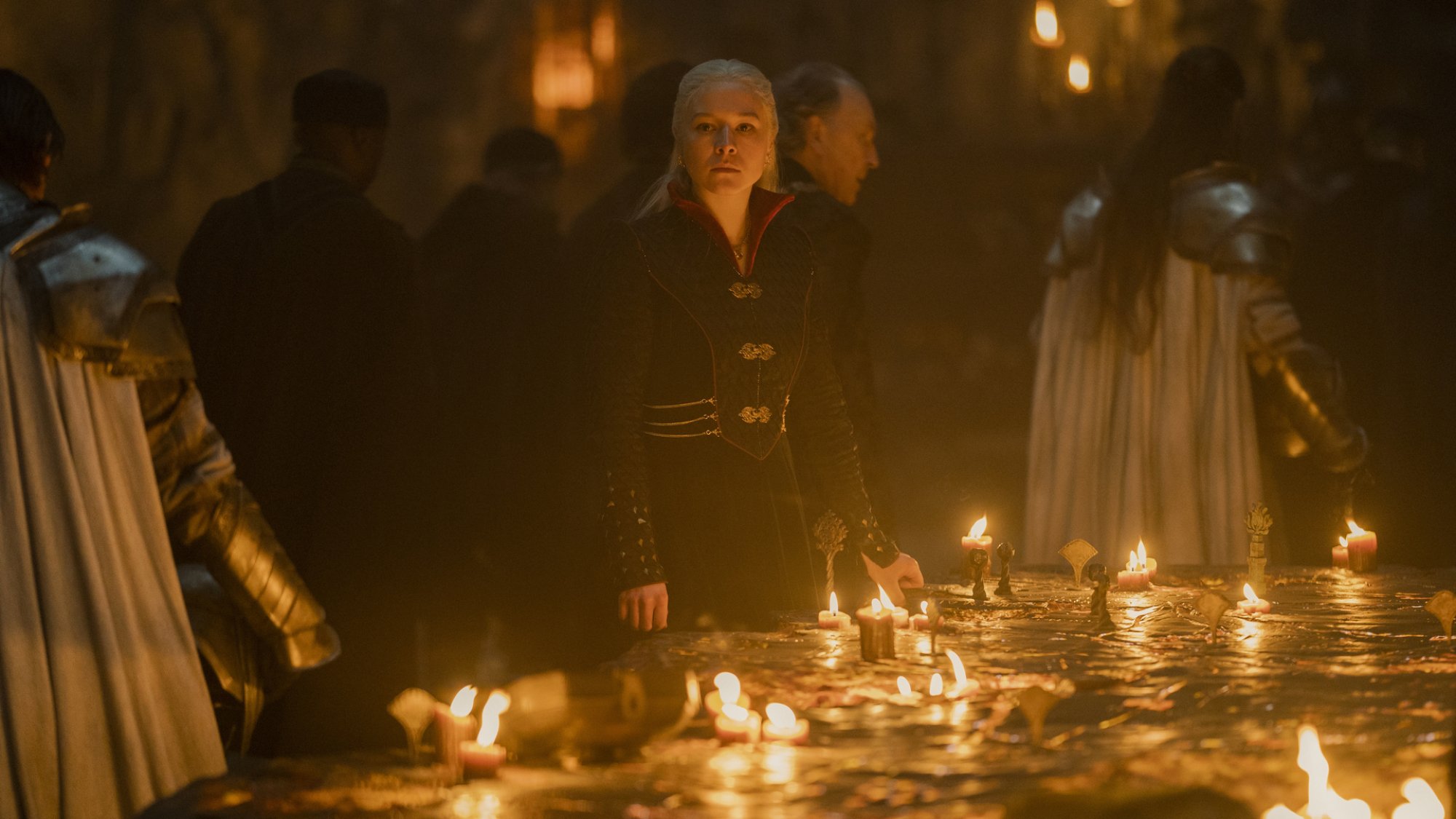 Emma D'Arcy stands at a candlelit war table as Rhaenyra Targaryen in "House of the Dragon."