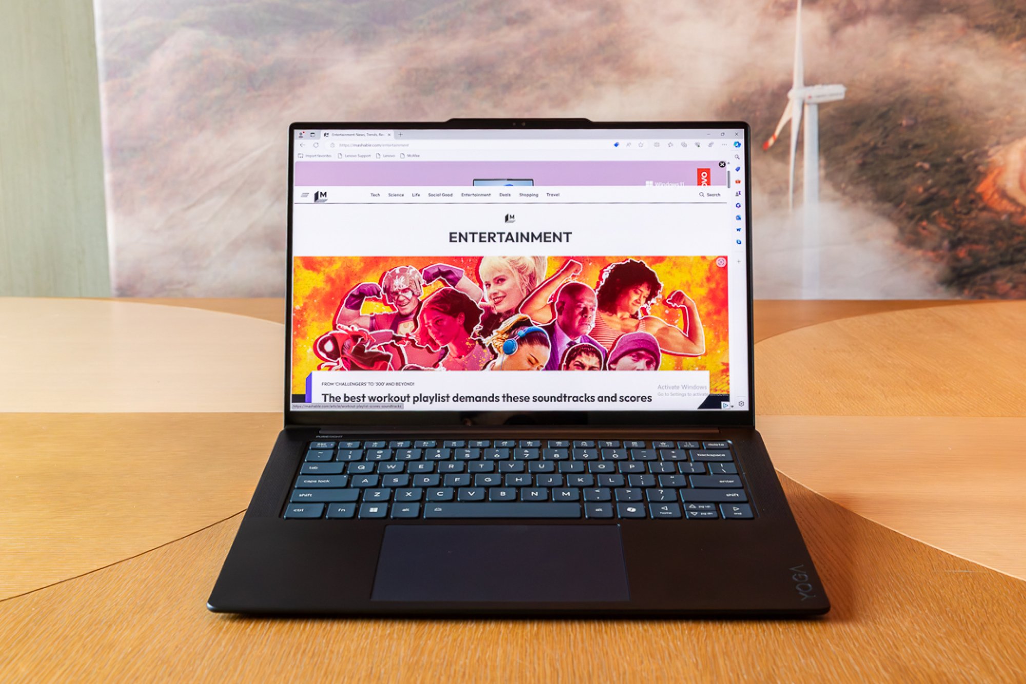 Lenovo Yoga Slim 7x on a table displaying a Mashable article