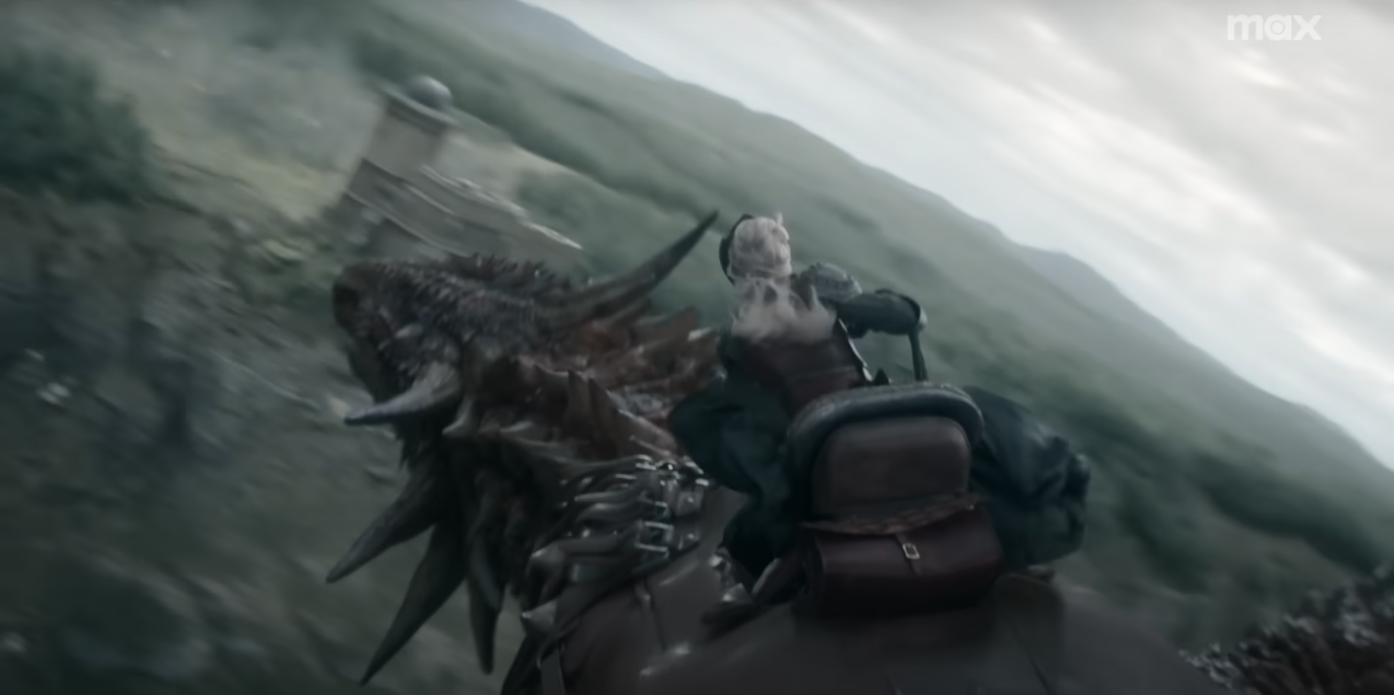 Eve Best as Rhaenys Targaryen rides a spiky red dragon.