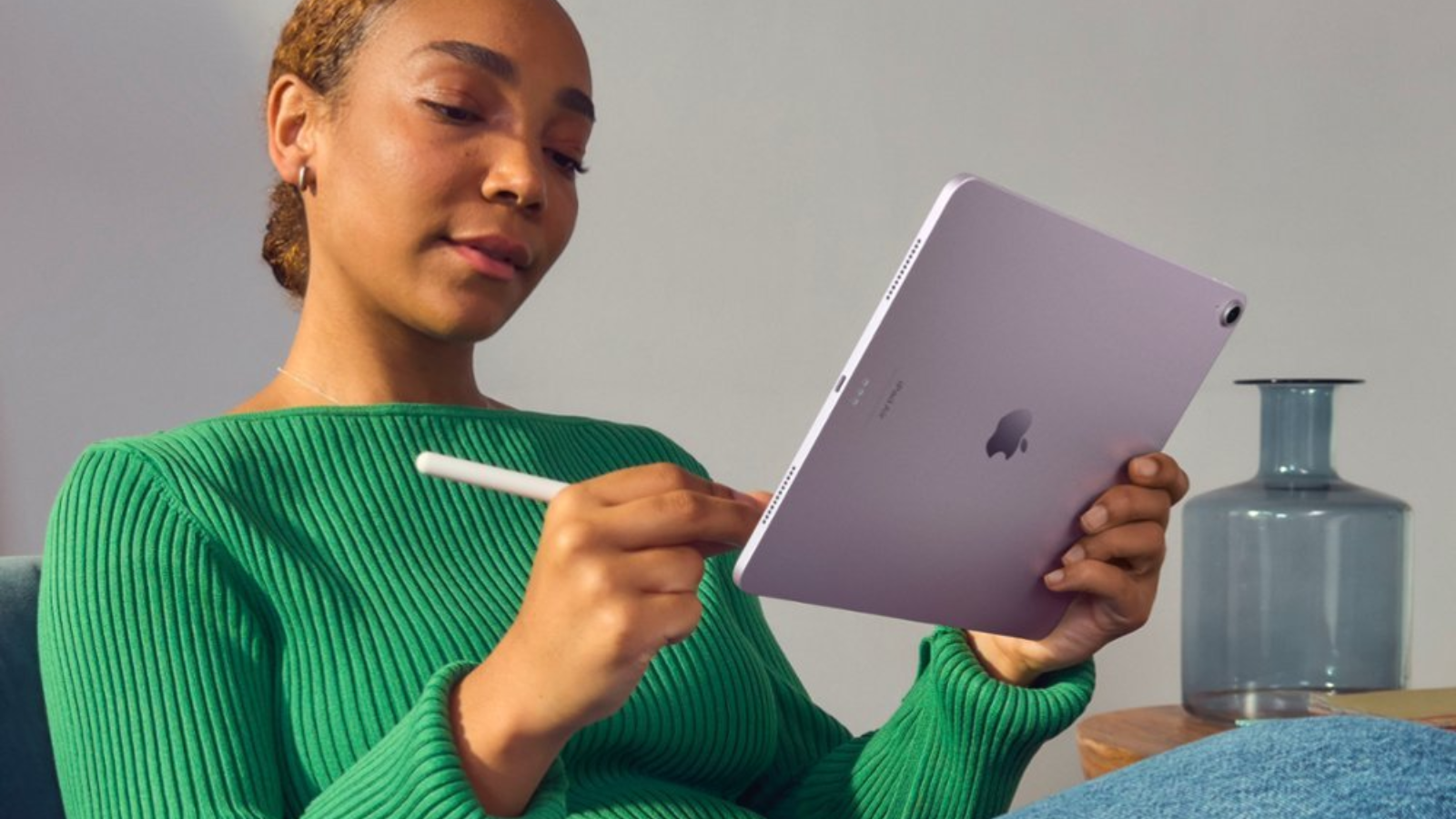 a close-up of a woman writing on an m2 apple ipad air with an apple pencil pro