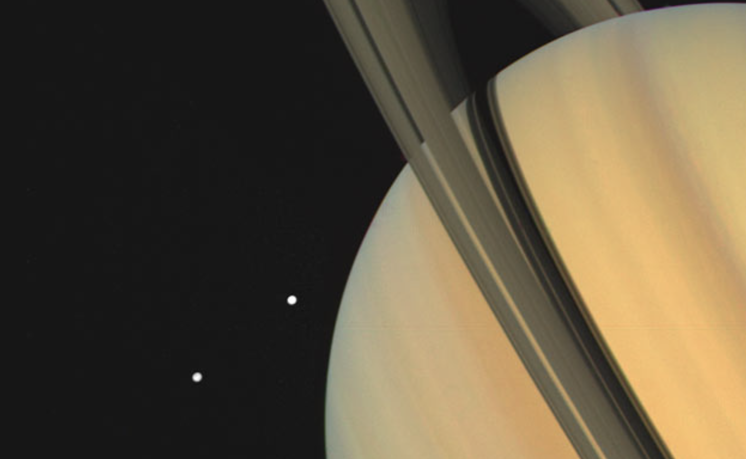 In November 1980, Voyager 1 snapped this image of Saturn and two of the gas giant's moons.