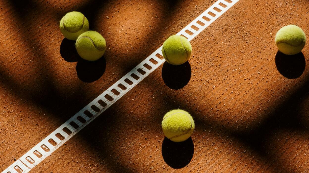 Tennis balls on a clay court