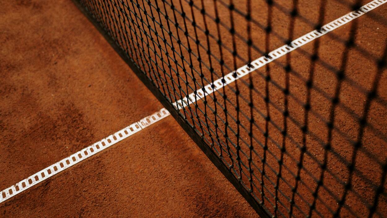 Tennis net on clay court