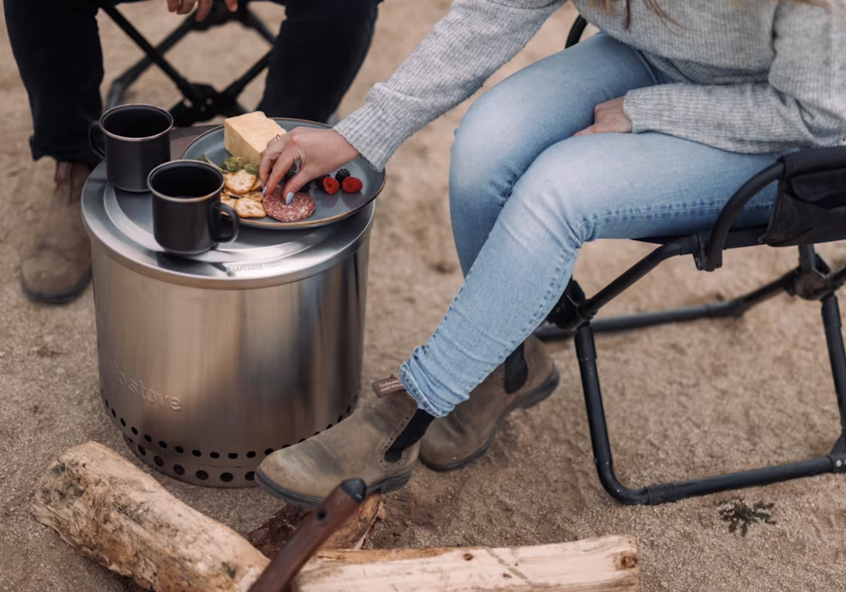 campers sit around the Solo Stove and have snacks