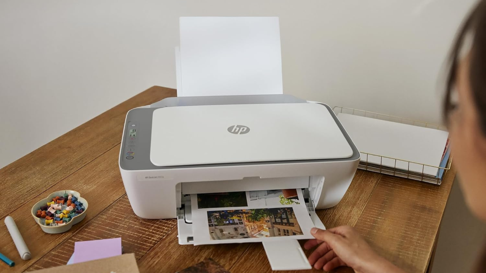 A person printing photos with an HP printer