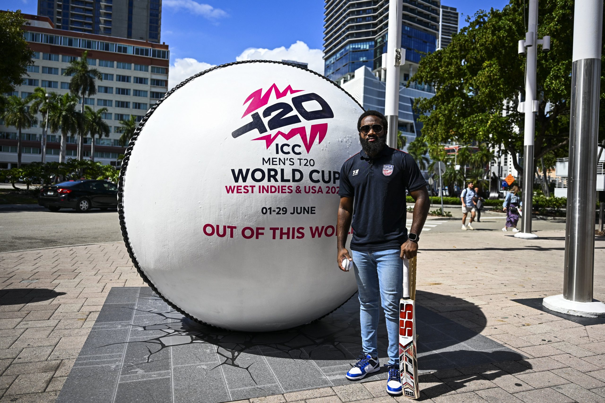 USA Cricket Vice-Captain Aaron Jones poses next to a giant cricket ball