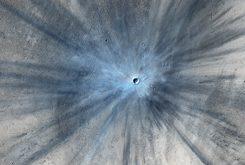 NASA's Mars Reconnaissance Orbiter captured an image of a fresh impact crater on Mars in 2013.