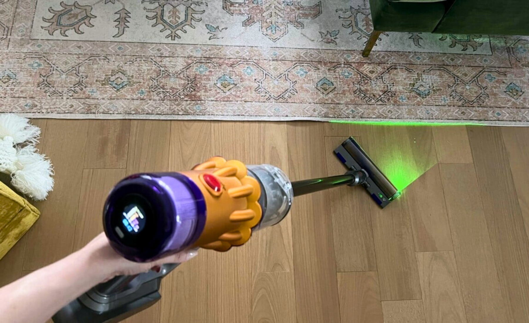 Person's hand holding Dyson V12 Detect Slim cordless vacuum