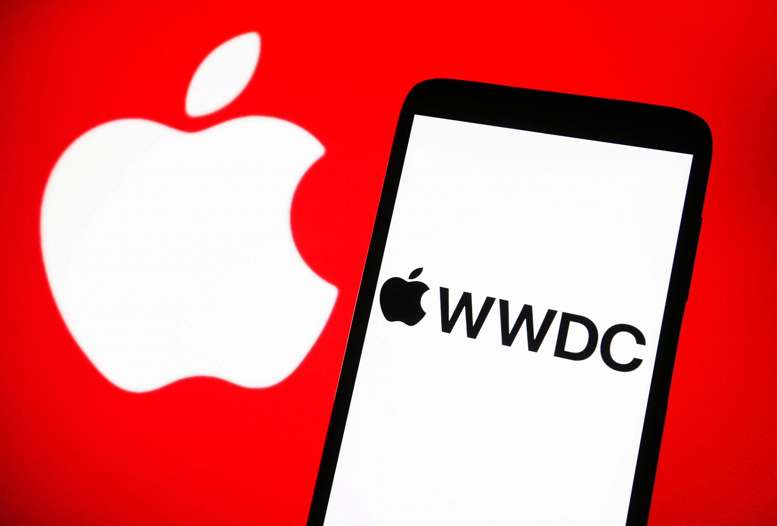 photo illustration, Worldwide Developers Conference (WWDC) logo is seen on a smartphone screen