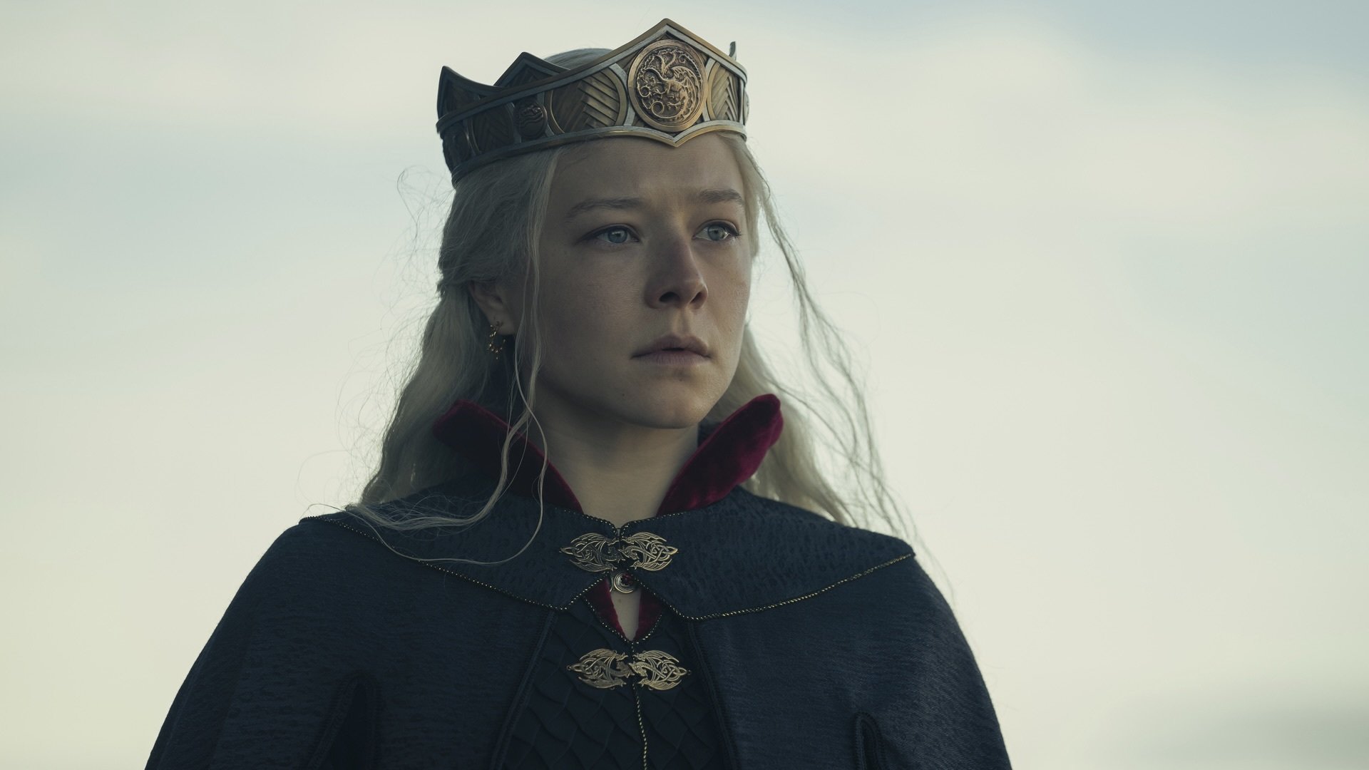 Rhaenyra Targaryen in a black gown with a crown on her head.