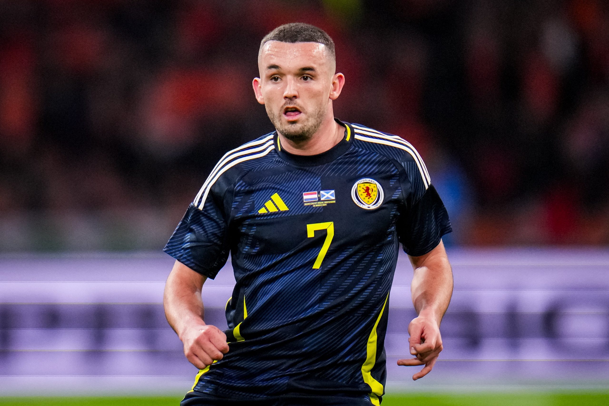 John McGinn of Scotland looks on