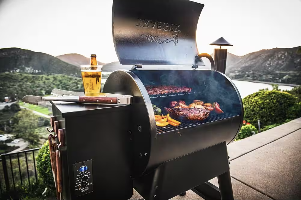 A Traeger grill loaded up with food