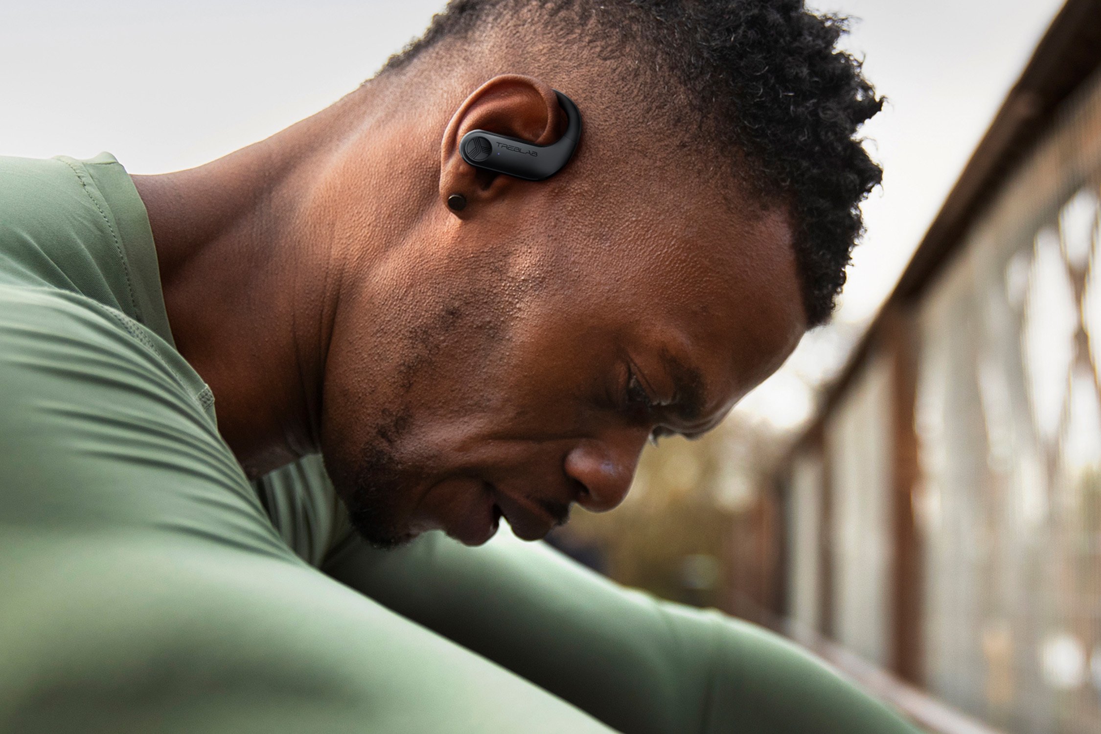 Man working out with earbuds in.