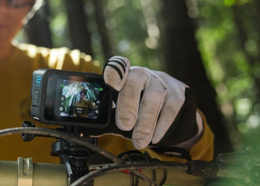 A GoPro Hero 12 camera is mounted on a mountain bike 