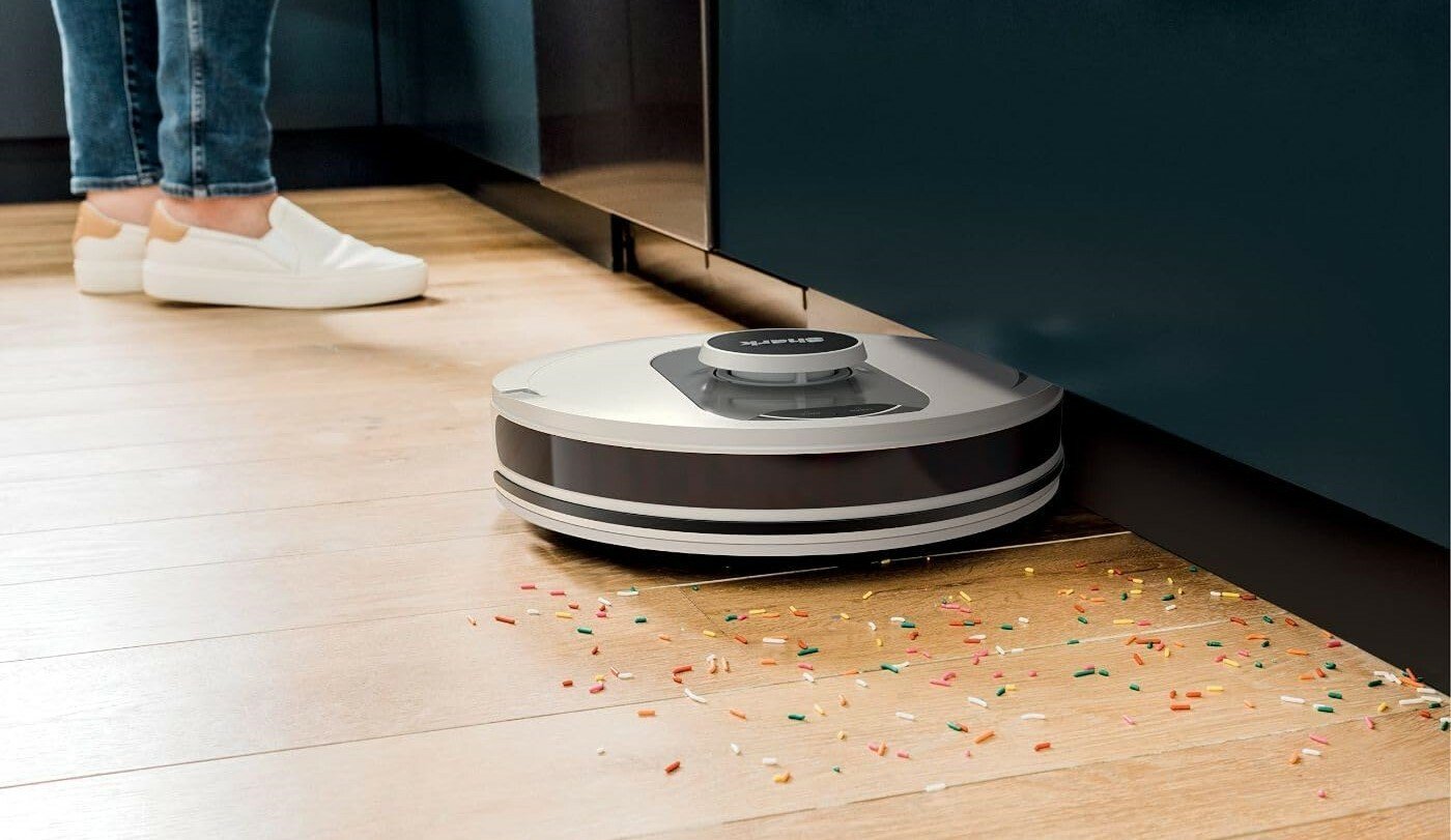 the shark AI ultra robot vacuum picks up colorful sprinkles on a hardwood floor