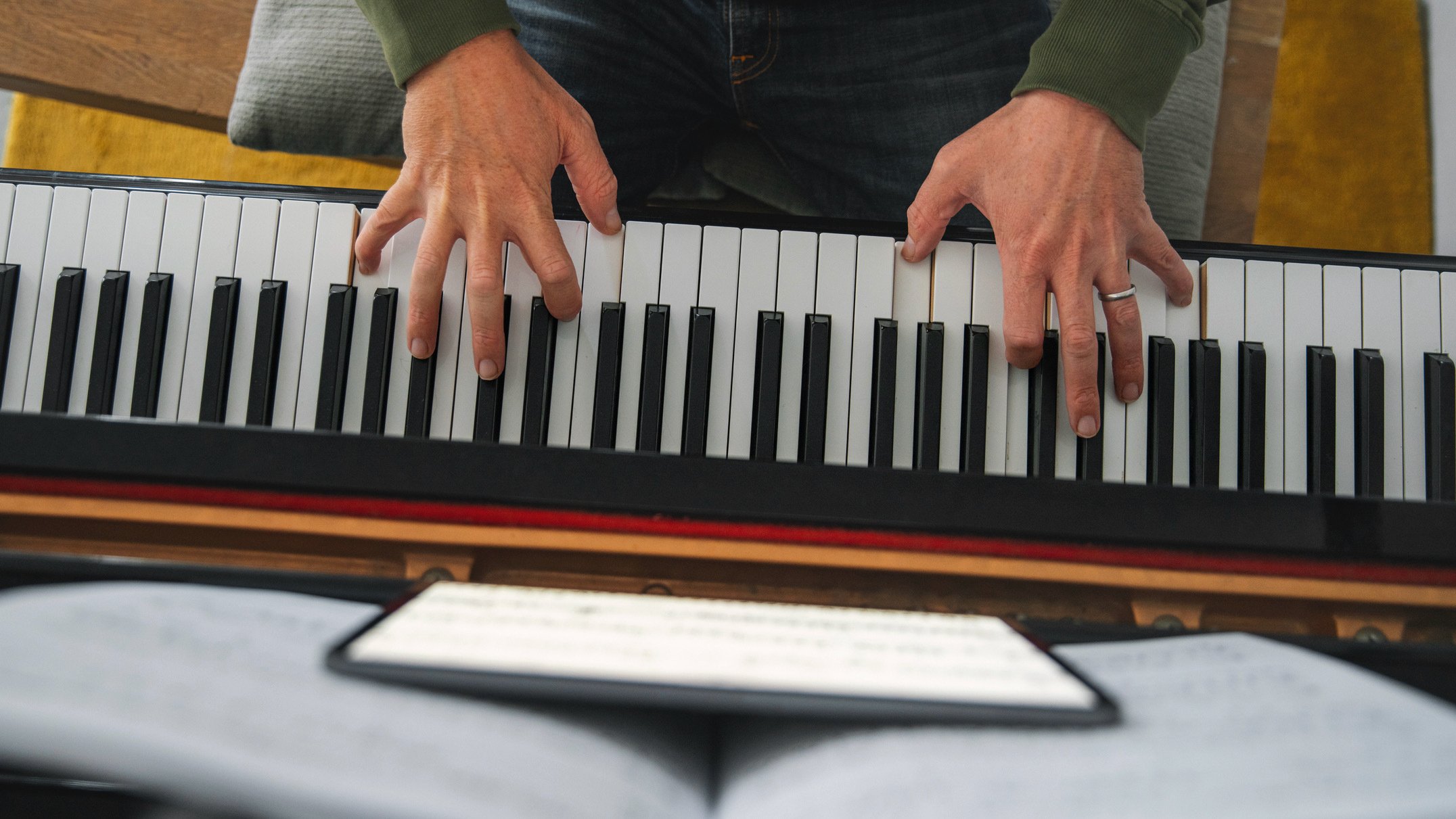 man taking piano lessons on tablet