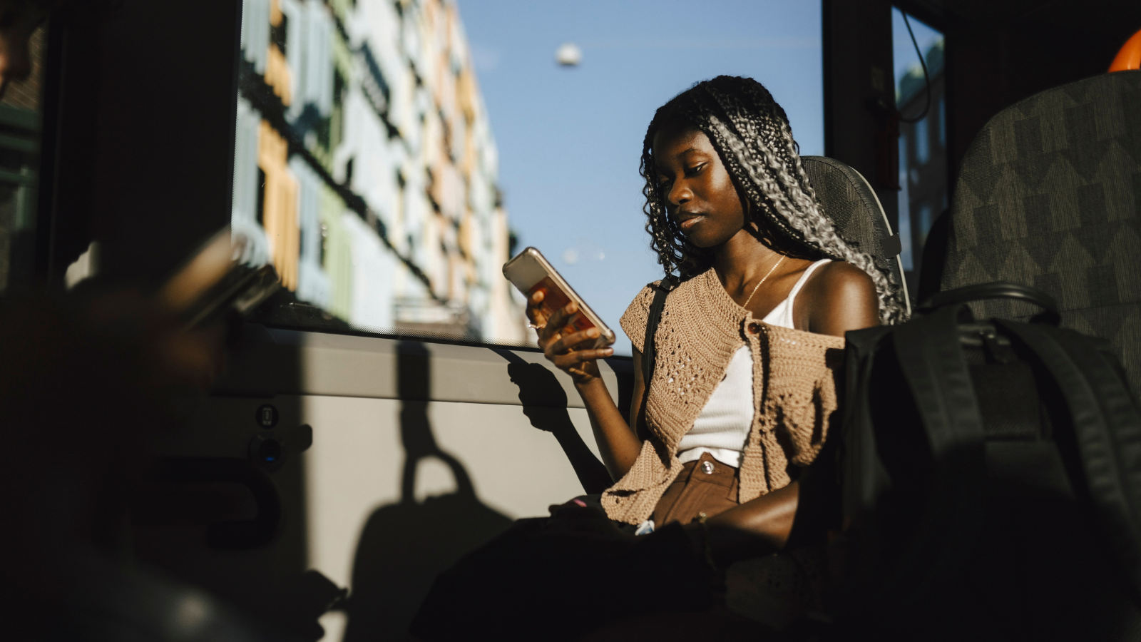 woman on bus using cell phone