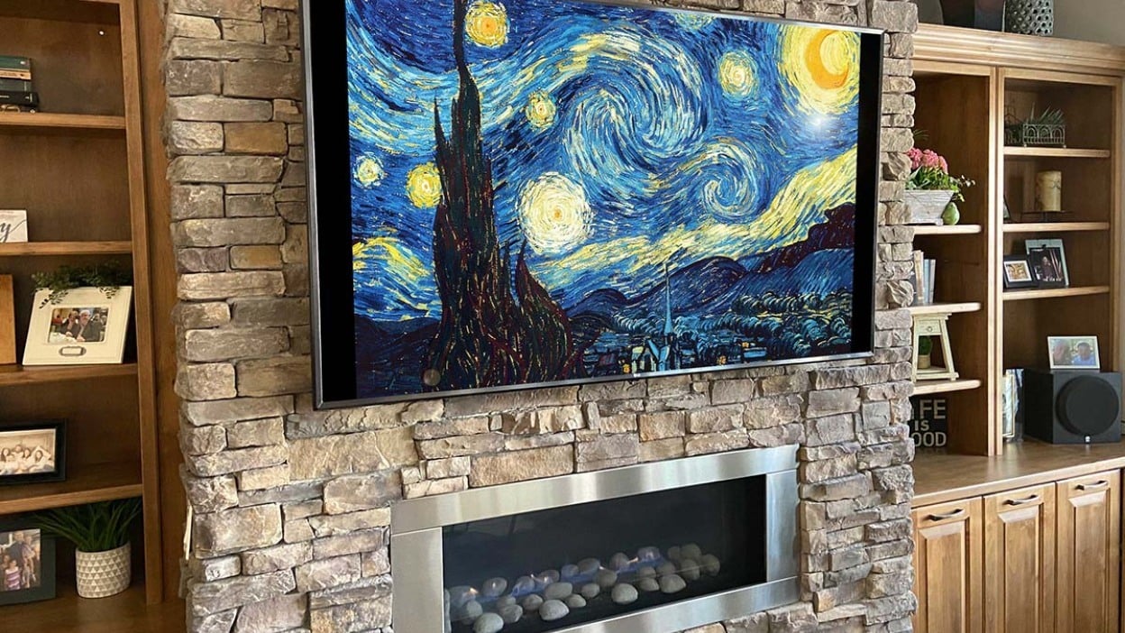 tv displaying Vincent van Gogh's 'starry night' above fireplace