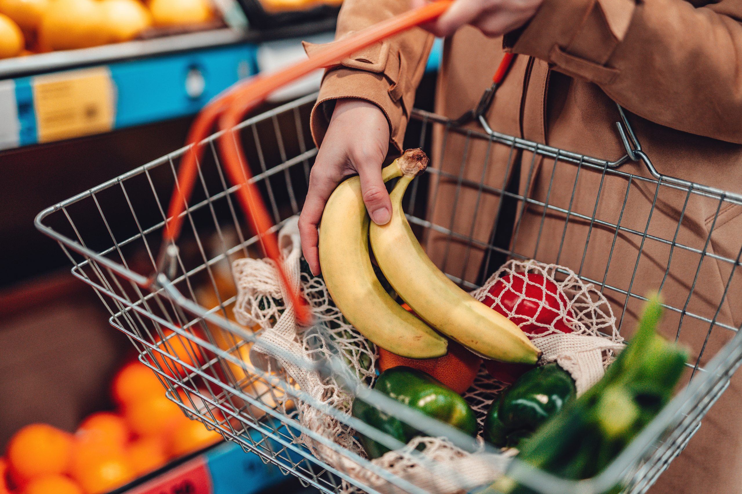 A grocery basket filled with produce.