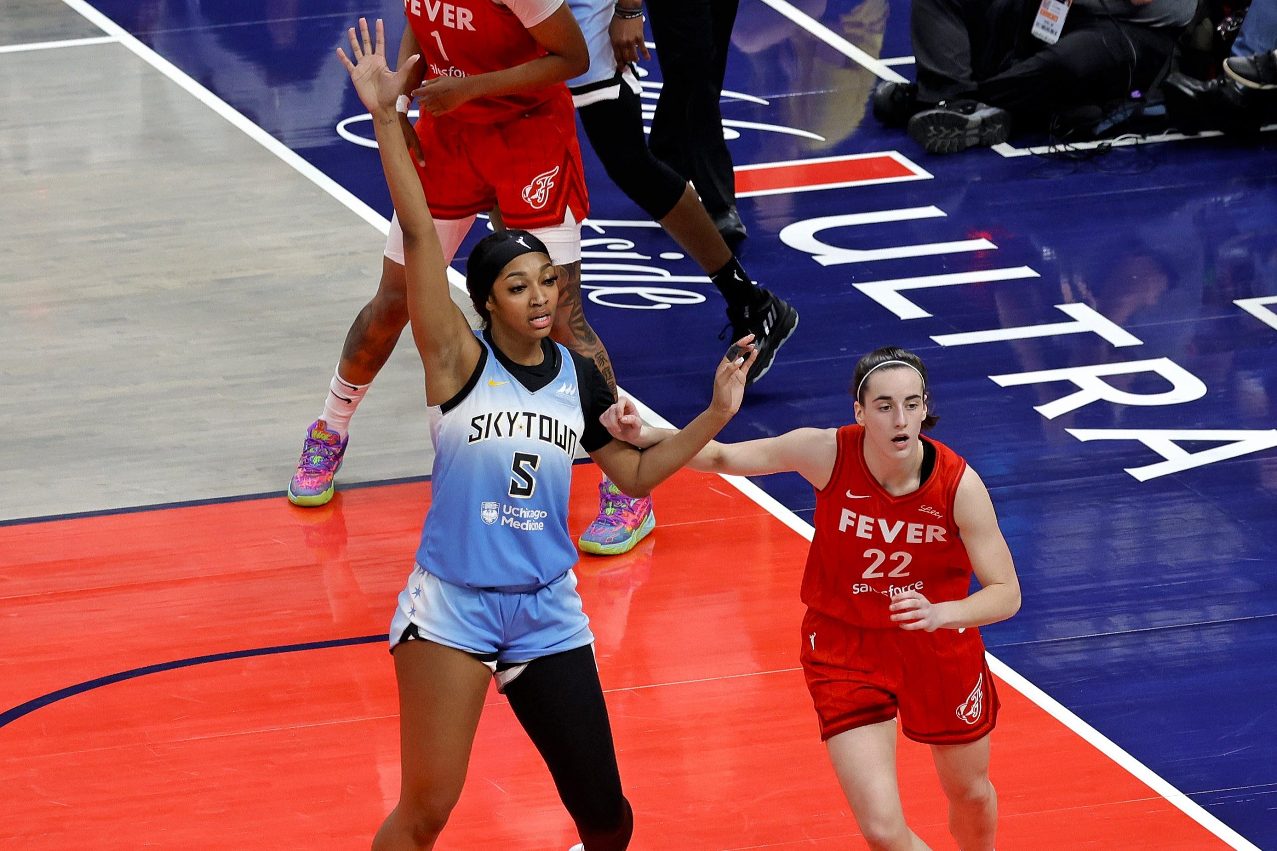 Chicago Sky forward Angel Reese is guarded by Indiana Fever guard Caitlin Clark