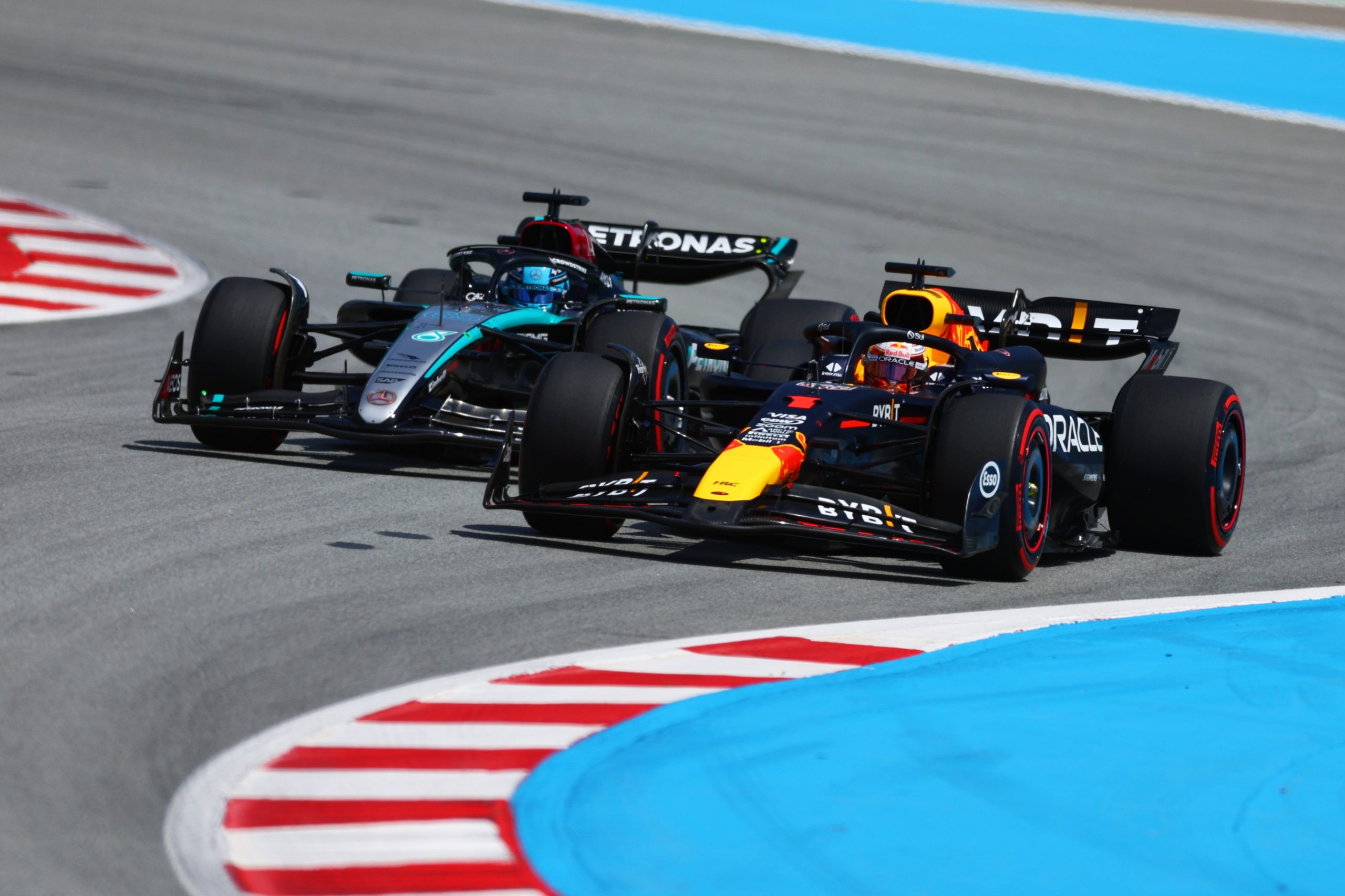 Max Verstappen of the Netherlands driving the Oracle Red Bull Racing RB20 overtakes George Russell